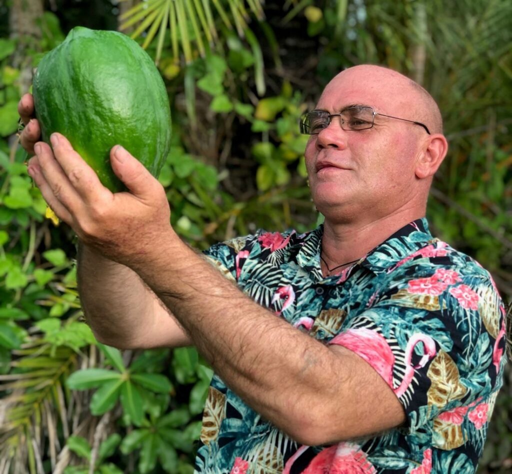Darren McArthur of Real McArthur Paw Paw Products holding a fresh Australian paw paw